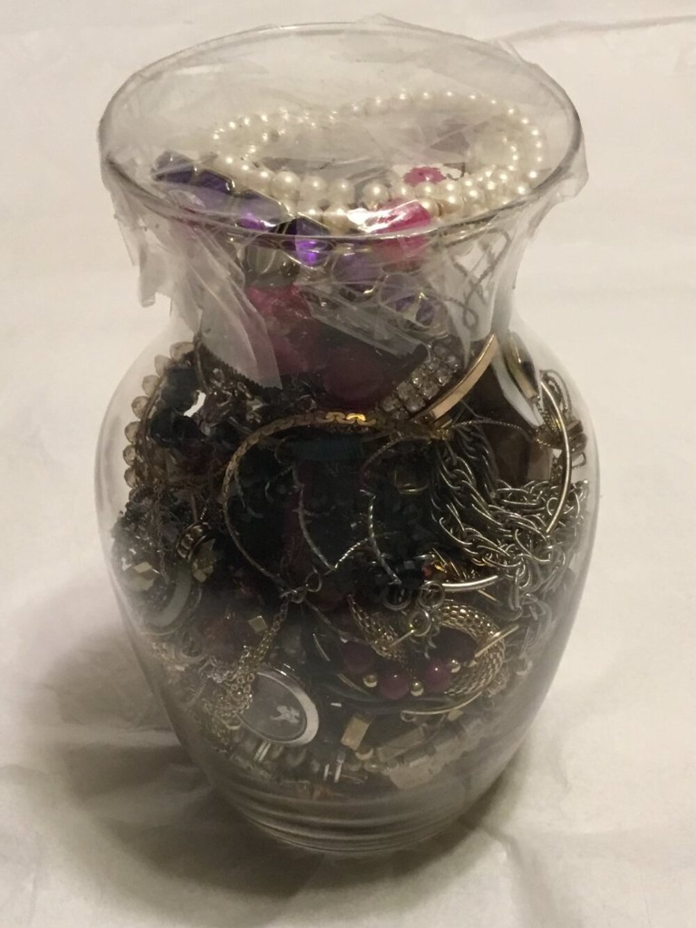 Large glass vase filled with lots of good, wearable jewelry